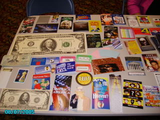 A variety of colorful Gospel tracts, including money tracts, displayed on a table at Tri Lakes Church.
